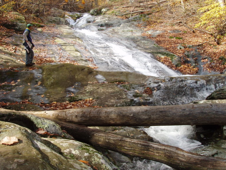 Joseph P Fisher crossing a stream in Shenandoah National Park