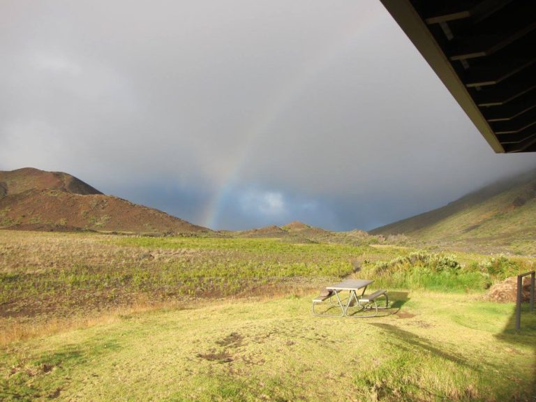 a rainbow against a gray cloud at Kapalaoa Cabin