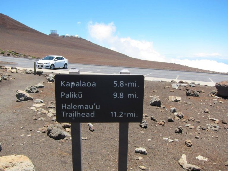 trail mileage sign at Sliding Sands trailhead reading Kapalaoa 5.8 Paliku 9.8 Halemauu Trailhead 11.2