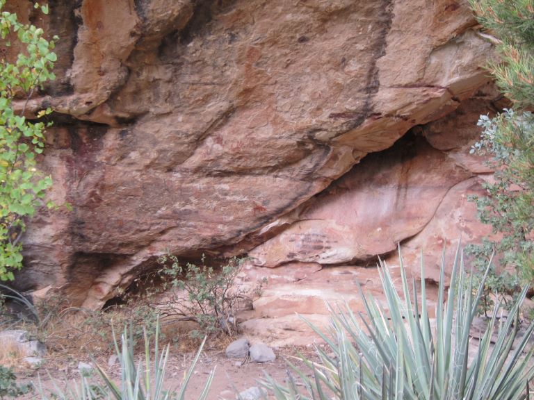 nondescript tiny red petroglyph on a red rock that looks something like a buffalo